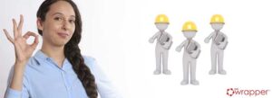 A woman making an "OK" hand gesture next to three stylized team members in hard hats with qmsWrapper branding, illustrating the reliability and high employee morale found in an automated eQMS over paper-based systems.