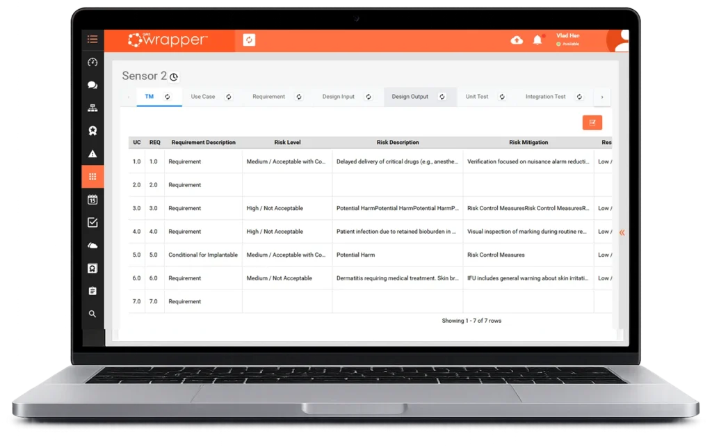 Design Control Software for Medical Devices: Laptop screen displaying the qmsWrapper Traceability Matrix with linked use cases, requirements, risk levels, risk mitigation, and test records in a live, connected DHF view.