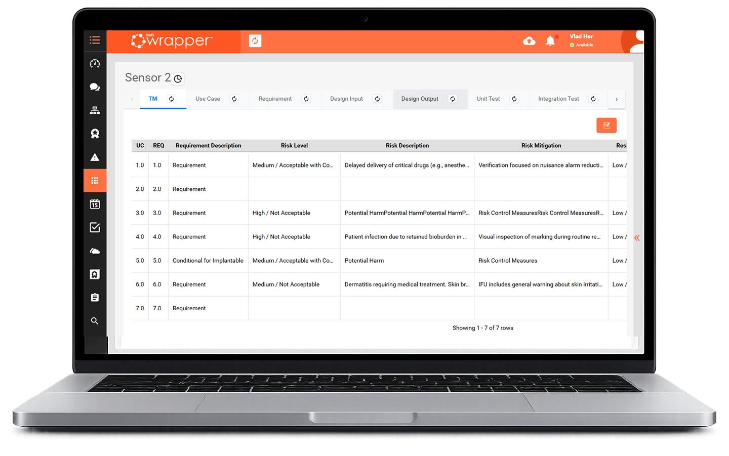 Design Control Software for Medical Devices: Laptop screen displaying the qmsWrapper Traceability Matrix with linked use cases, requirements, risk levels, risk mitigation, and test records in a live, connected DHF view.